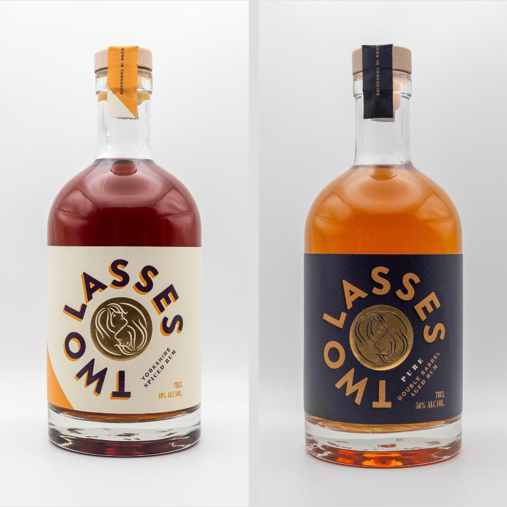 Two Lasses Rum product shot showing Yorkshire Spiced Liqueur and PURE Rum on a clean white background.